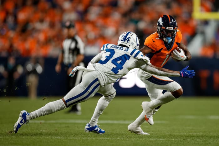 Oct 6, 2022; Denver, Colorado, USA; Denver Broncos wide receiver KJ Hamler (1) runs the ball under pressure from Indianapolis Colts cornerback Isaiah Rodgers Sr. (34) in the second quarter at Empower Field at Mile High. Mandatory Credit: Isaiah J. Downing-USA TODAY Sports
